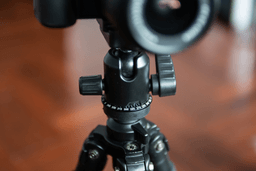 A camera on a tripod ready to film a video for a car dealership