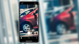 A car dealer on Facebook Stories taking a story video in a car lot, outside
