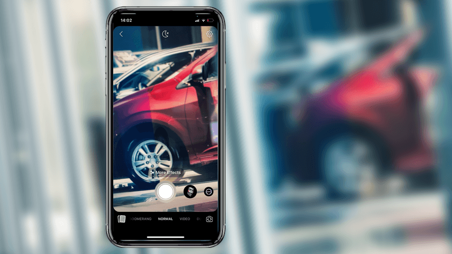 A car dealer on Facebook Stories taking a story video in a car lot, outside
